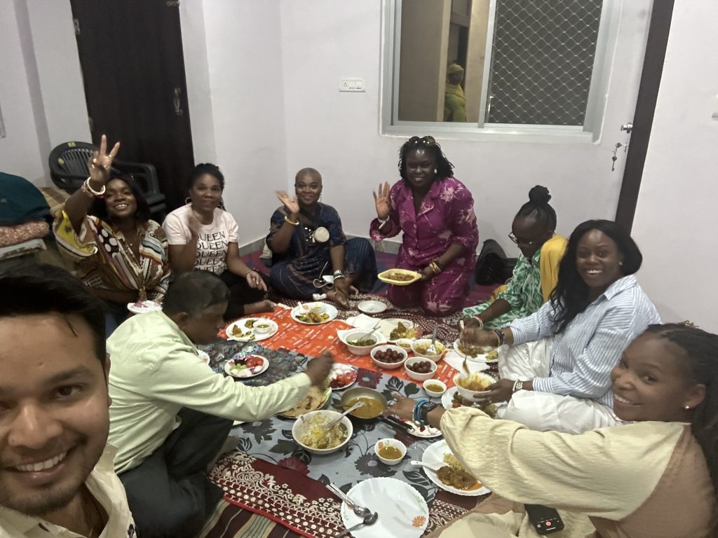 Black women enjoying a group trip abroad learning to cook in India