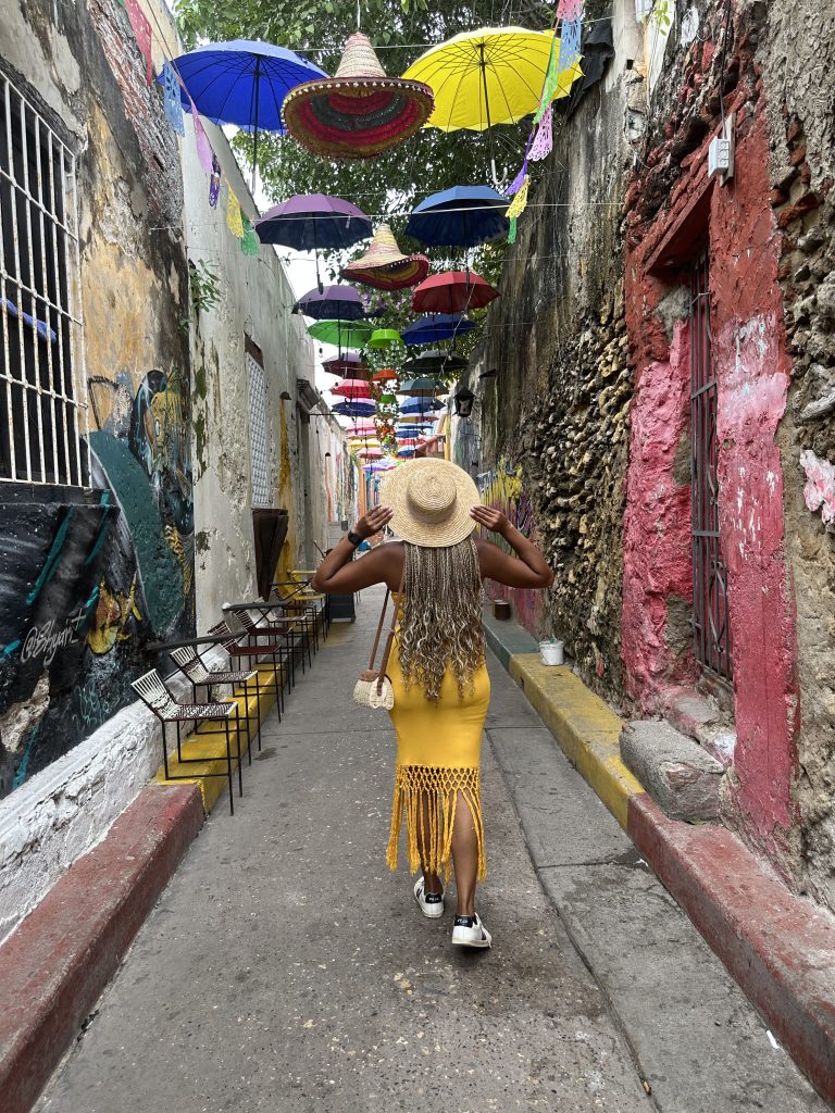 How To Get Back Into Routine After Travelling Without Feeling Deflated Black British woman travelling solo in Colombia solo traveller travel insurance for solo travellers